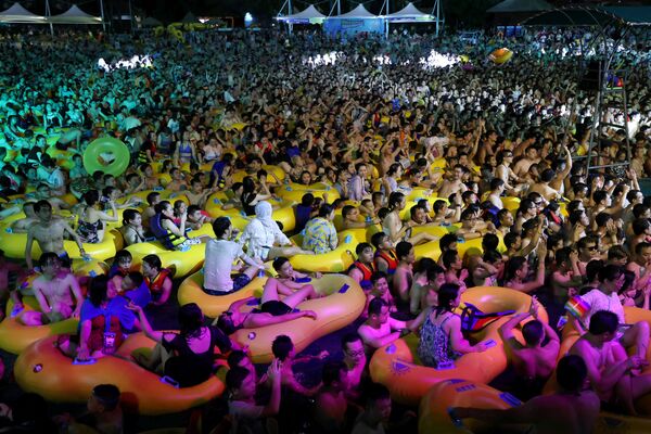 Pessoas desfrutam de uma festa de música dentro de uma piscina no Wuhan Maya Beach Park, em Wuhan, China - Sputnik Brasil