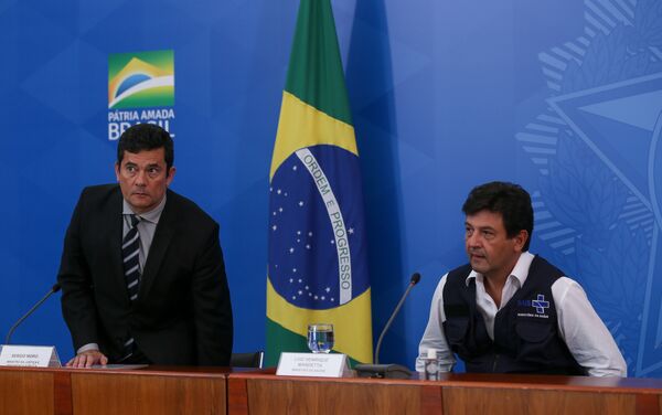 Ministros Luiz Henrique Mandetta (Saúde) Paulo Guedes (Economia) Sergio Moro (Justiça) e general Walter Braga Netto (Casa Civil), durante coletiva de imprensa sobre as novas ações do governo no combate a pandemia causada pelo novo coronavírus (Covid-19), no Palácio do Planalto, em Brasília (DF) Ministros Luiz Henrique Mandetta (Saúde) Paulo Guedes (Economia) Sergio Moro (Justiça) e general Walter Braga Netto (Casa Civil), durante coletiva de imprensa sobre as novas ações do governo no combate a pandemia causada pelo novo coronavírus (Covid-19), no Palácio do Planalto, em Brasília (DF) - Sputnik Brasil