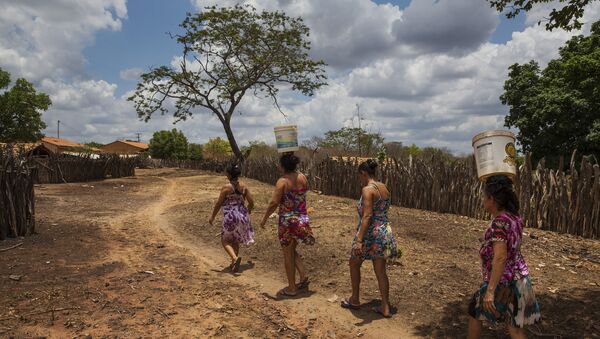 Mulheres carregam baldes de água em do povoado de Queimadas do Angico, em Guaribas, no interior do Piauí, principal reduto de votos petistas no país no primeiro turno das eleições de 2018 - Sputnik Brasil