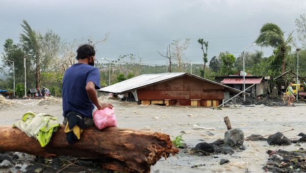 Em Daraga, nas Filipinas, um homem observa sua casa submersa durante inundação causada pela passagem do tufão Goni, em 1º de novembro de 2020 - Sputnik Brasil