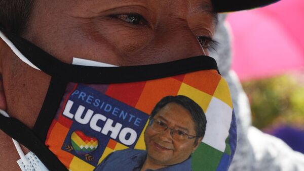 Homem passeia com máscara com rosto do presidente boliviano Luis Arce - Sputnik Brasil