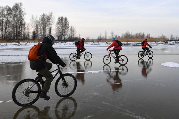 Ciclistas pedalam em reservatório congelado de hidrelétrica, perto da ilha Tan-Van, na Sibéria - Sputnik Brasil