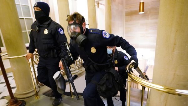 Policiais do tomam posições no Congresso dos EUA enquanto os manifestantes entram no prédio durante uma sessão conjunta para certificar os resultados das eleições de 2020 no Capitólio em Washington, EUA, 6 de janeiro de 2021 - Sputnik Brasil