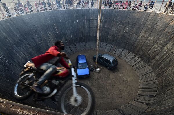 Motociclista acrobata executa acrobacia no show Wall of Death (Muro da Morte, em português) durante festival na Índia, 20 de janeiro de 2021 - Sputnik Brasil