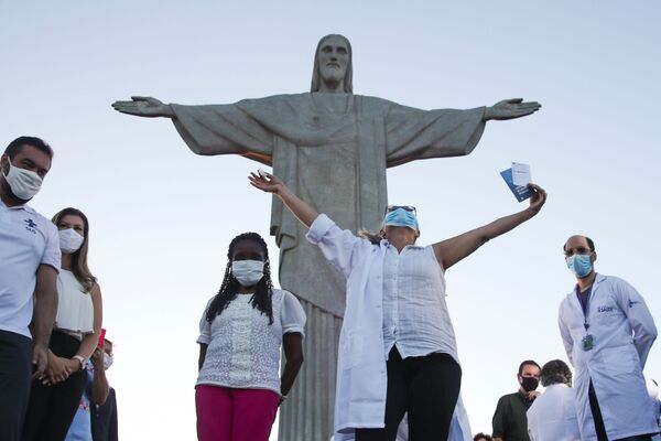 Dulcineia da Silva Lopes levanta as mãos após ter recebido a vacina Sinovac na estátua do Cristo Redentor em Rio de Janeiro, Brasil, 18 de janeiro de 2021 - Sputnik Brasil