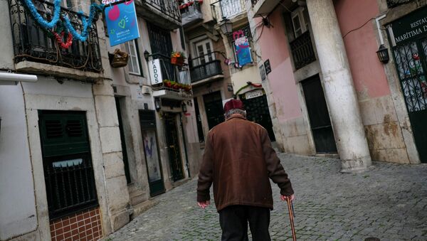 Homem caminhando no bairro de Alfama em meio à pandemia da COVID-19 em Portugal, 11 de março de 2021 - Sputnik Brasil