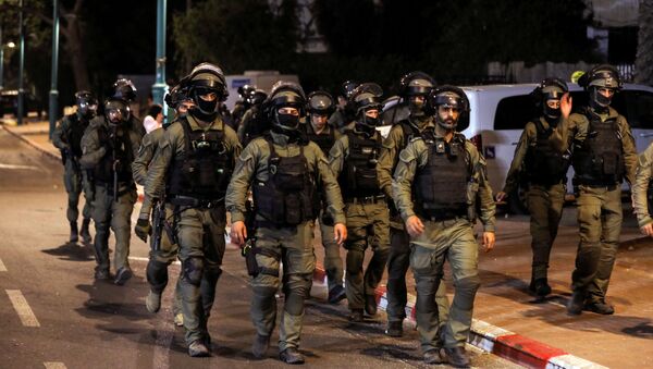 Membros da força de segurança israelense patrulham durante toque de recolher noturno após violência na cidade árabe-judaica de Lod, em Israel, em 12 de maio de 2021 - Sputnik Brasil