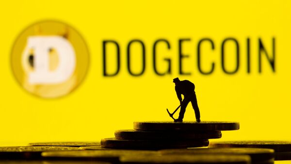 A small toy figure is seen on the cryptocurrency representation with Dogecoin logo in the background in this illustration picture taken, April 20, 2021. - Sputnik Brasil