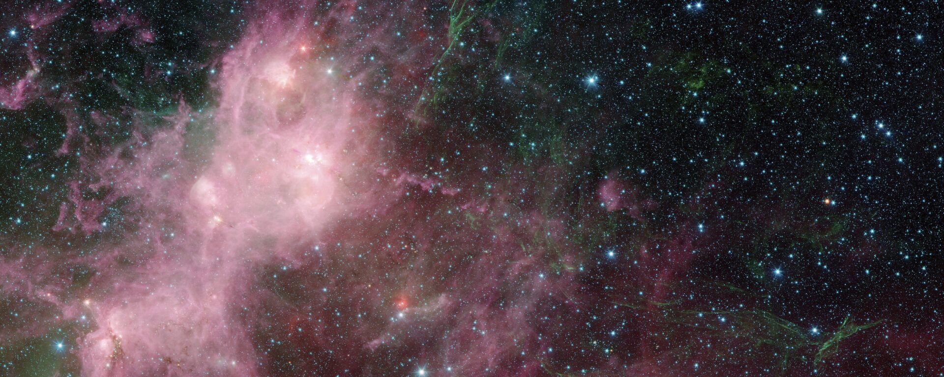 Imagem fornecida pela NASA de dados infravermelhos obtidos pelo telescópio espacial Spitzer e pelo telescópio Wide Field Infrared Explorer (WISE) em uma área onde estrelas conhecidas como W3 e W5 se formam na Via Láctea - Sputnik Brasil, 1920, 08.08.2024