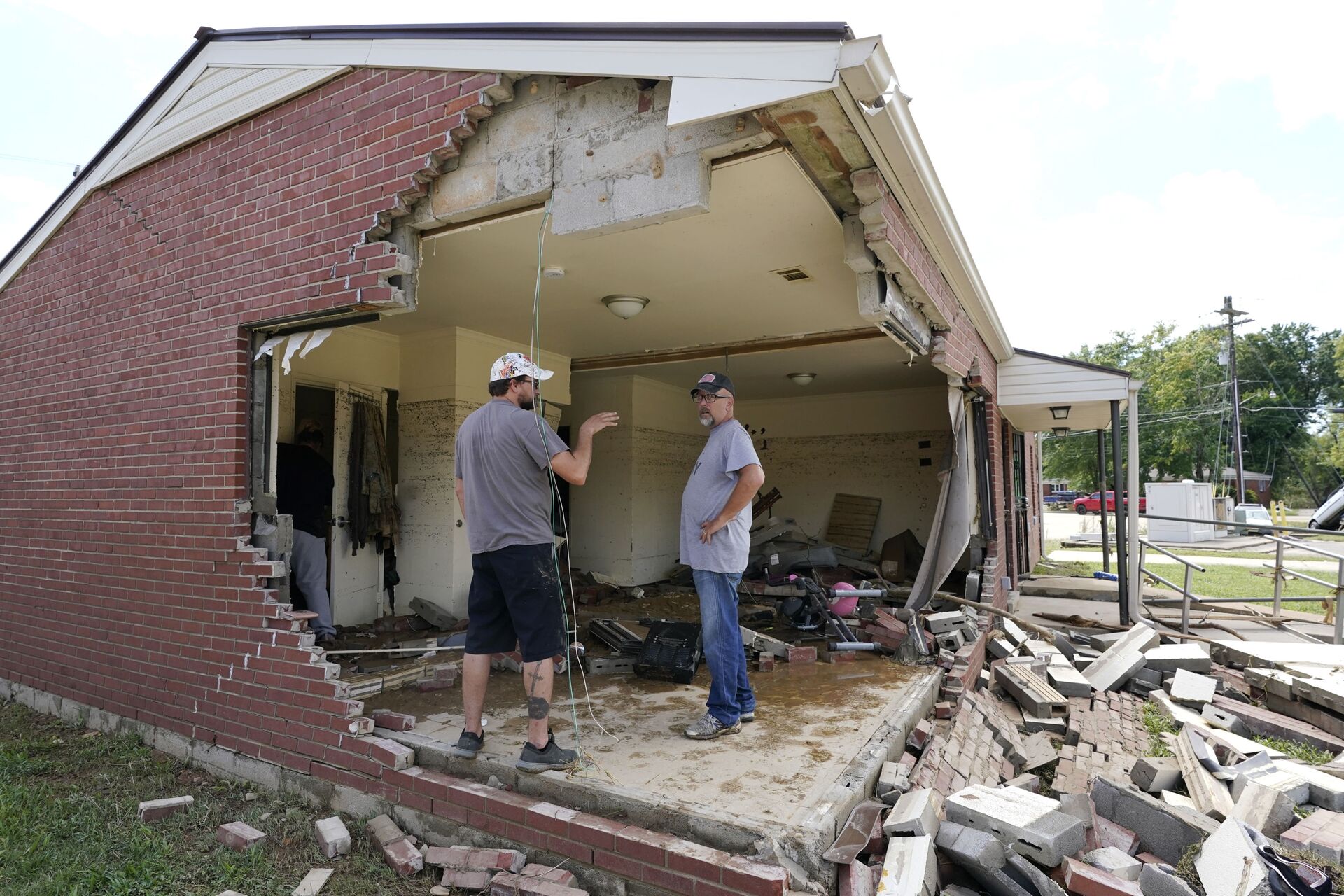 Brian Mitchell (à direita) olha para a casa destruída da sua sogra com um amigo da família, Chris Hoover. Chuvas fortes causaram inundações e estragos no estado de Tennessee, EUA - Sputnik Brasil, 1920, 09.11.2021