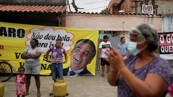 Cartaz criticando o presidente Jair Bolsonaro no local onde o Sindicato dos Petroleiros da Petrobras vende gás de cozinha de baixo custo, na favela Vila Vintém, Rio de Janeiro, 28 de outubro de 2021 - Sputnik Brasil