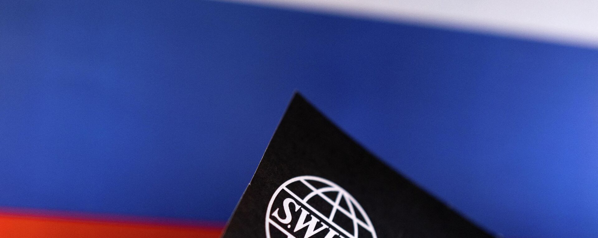 A logo da Sociedade Mundial de Telecomunicações Financeiras Interbancárias (SWIFT) com as cores da bandeira russa ao fundo - Sputnik Brasil, 1920, 26.02.2022