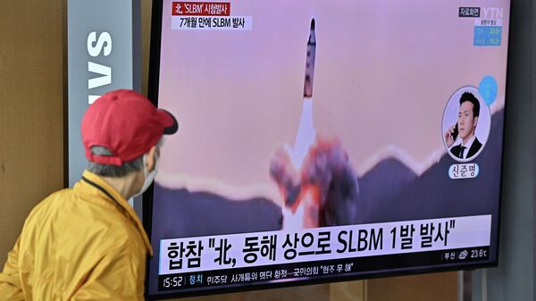 Espetador observa tela televisiva mostrando lançamento de míssil balístico lançado pela Coreia do Norte, em estação ferroviária de Seul, Coreia do Sul, 7 de maio de 2022 - Sputnik Brasil