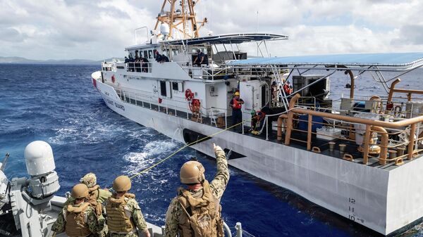 Marinheiros em barco de patrulha Mark VI comunicando com Oliver Henry (WPC 1140), navio de Guarda Costeira dos EUA, durante exercício naval, mar das Filipinas, 16 de dezembro de 2020 - Sputnik Brasil