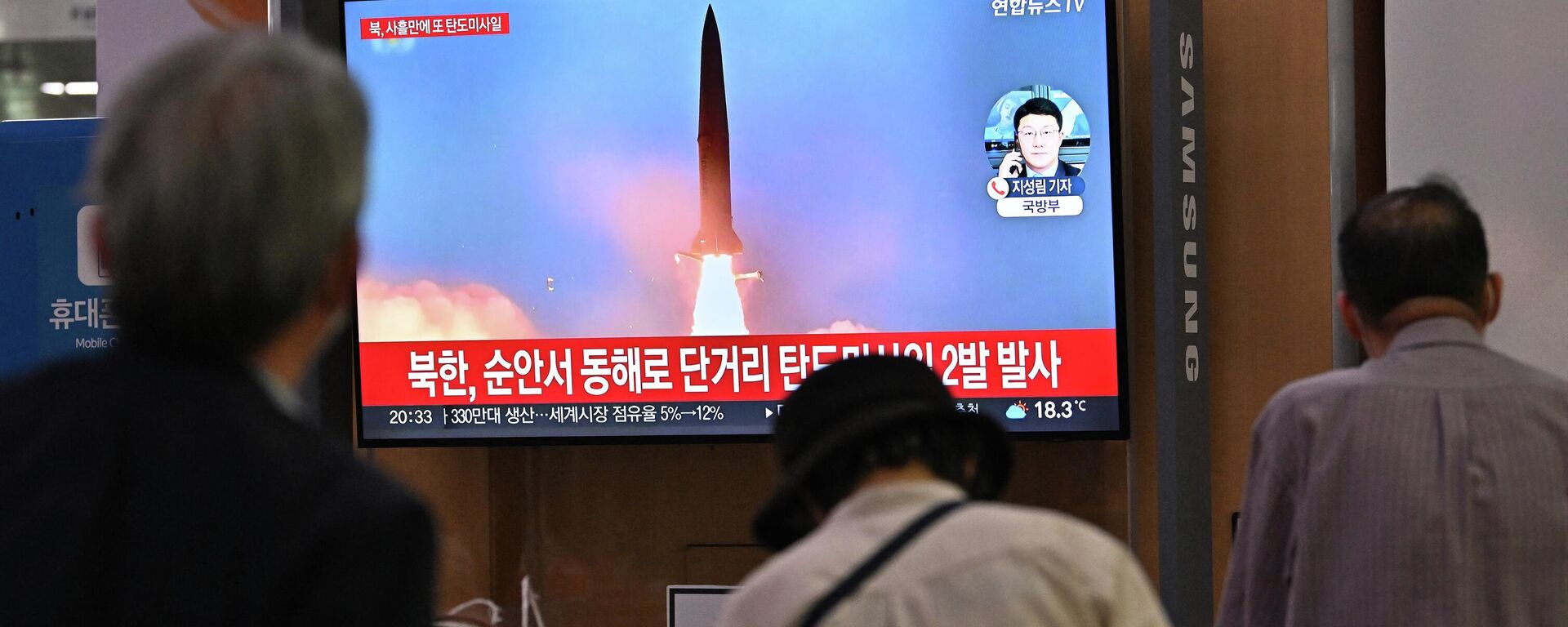 Pessoas observam tela televisiva mostrando lançamento de míssil norte-coreano em uma estação ferroviária de Seul, Coreia do Sul, 28 de setembro de 2022 - Sputnik Brasil, 1920, 05.10.2022