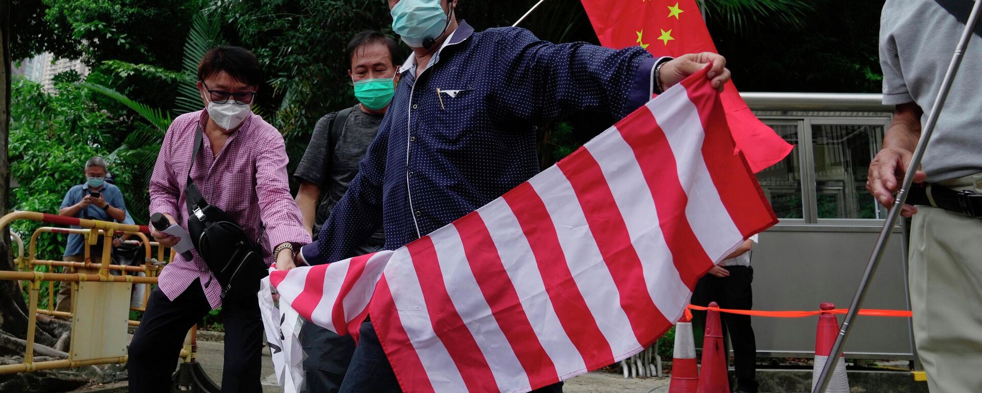 Apoiadores pró-chineses rasgam bandeira nacional dos EUA junto do consulado-geral do país norte-americano em Hong Kong, China, 3 de agosto de 2022 - Sputnik Brasil, 1920, 27.10.2022