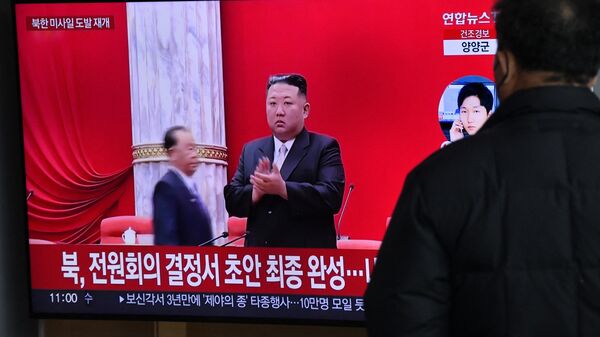 Um homem assiste a uma tela de televisão exibindo um noticiário com imagens de arquivo do líder norte-coreano Kim Jong-un, em uma estação ferroviária em Seul, 31 de dezembro de 2022 - Sputnik Brasil