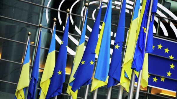 Bandeiras da Ucrânia e da União Europeia (UE) penduradas juntas no exterior do edifício antes de uma sessão plenária extraordinária sobre a Ucrânia no Parlamento Europeu em Bruxelas, 1º de março de 2022 - Sputnik Brasil
