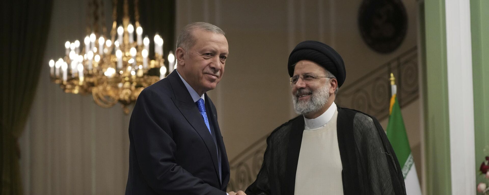 O presidente turco Recep Tayyip Erdogan, à esquerda, e seu homólogo iraniano, Ebrahim Raisi, apertam as mãos na conclusão de sua coletiva de imprensa conjunta no Palácio Saadabad, em Teerã, Irã,19 de julho de 2022 - Sputnik Brasil, 1920, 08.04.2023