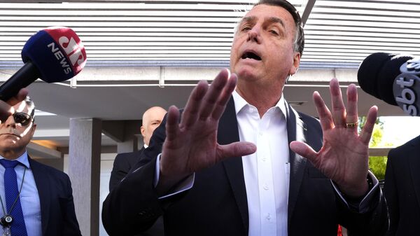 O ex-presidente brasileiro Jair Bolsonaro fala à imprensa do lado de fora de sua casa, depois que agentes da Polícia Federal cumpriram um mandado de busca e apreensão em Brasília, em 3 de maio de 2023 (foto de arquivo) - Sputnik Brasil