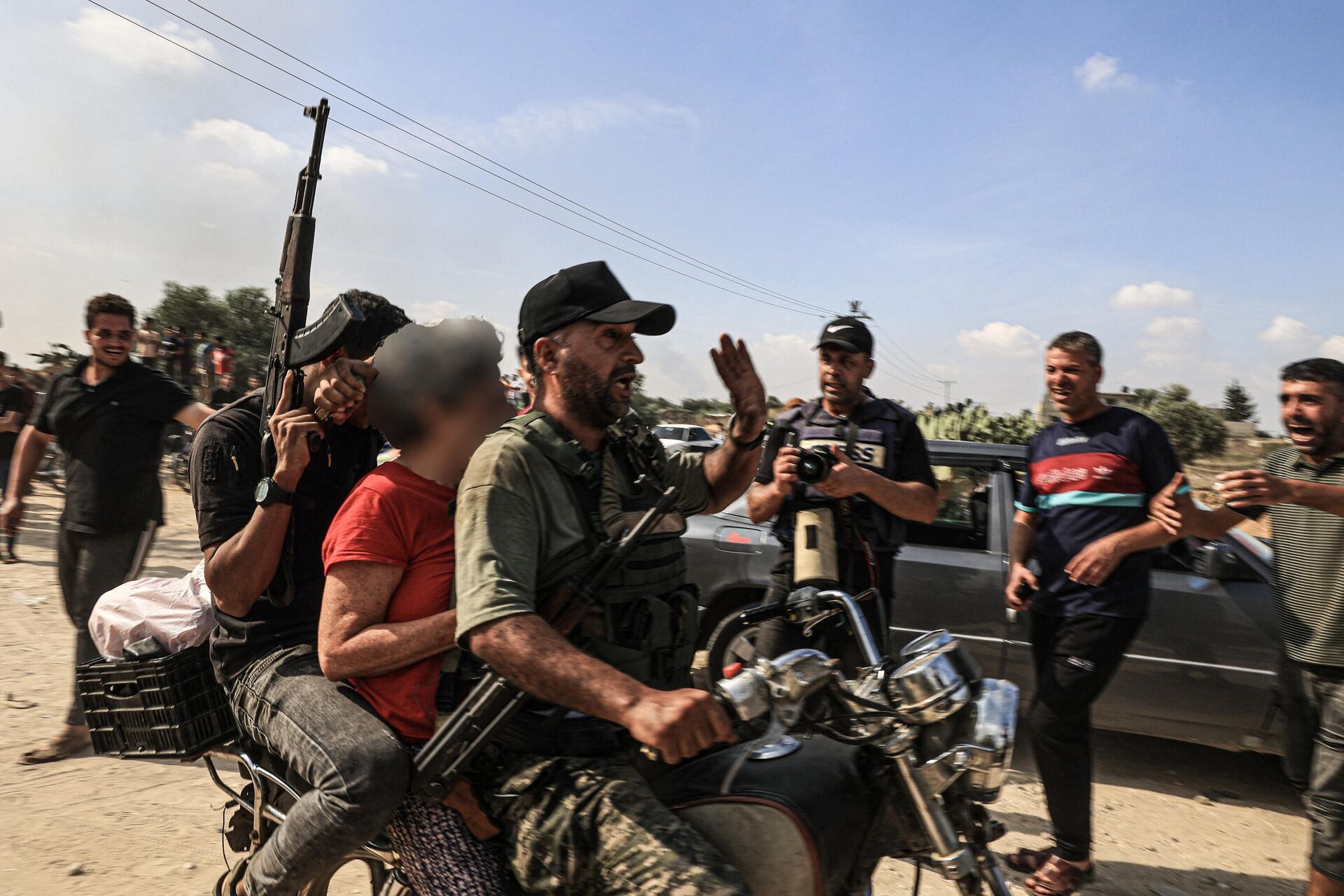 Militantes palestinos transportam uma mulher israelense supostamente capturada em uma motocicleta, em Khan Yunis, no sul da Faixa de Gaza, em 7 de outubro de 2023. - Sputnik Brasil, 1920, 07.10.2023