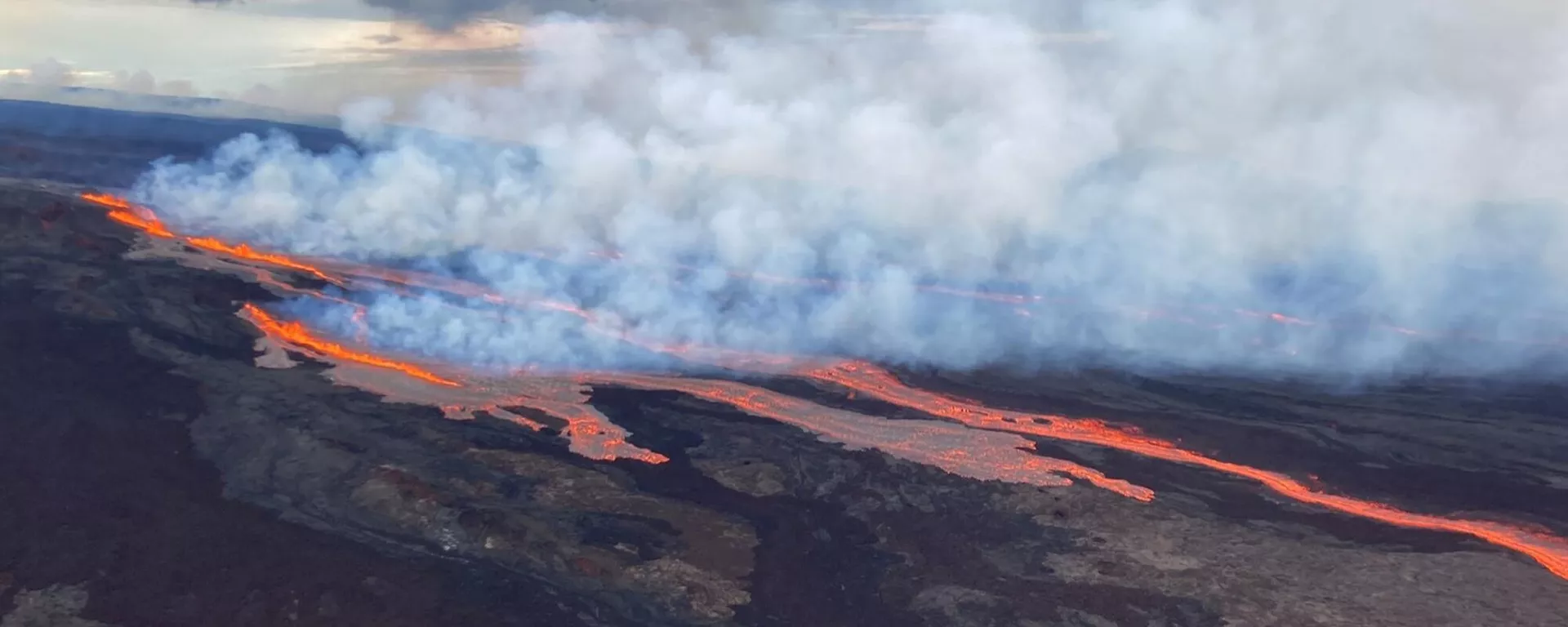 Nesta imagem aérea divulgada pelo Serviço Geológico dos Estados Unidos, o vulcão Mauna Loa é visto em erupção a partir de aberturas na zona nordeste da fenda, na Ilha Grande do Havaí, 28 de novembro de 2022 - Sputnik Brasil, 1920, 21.03.2024