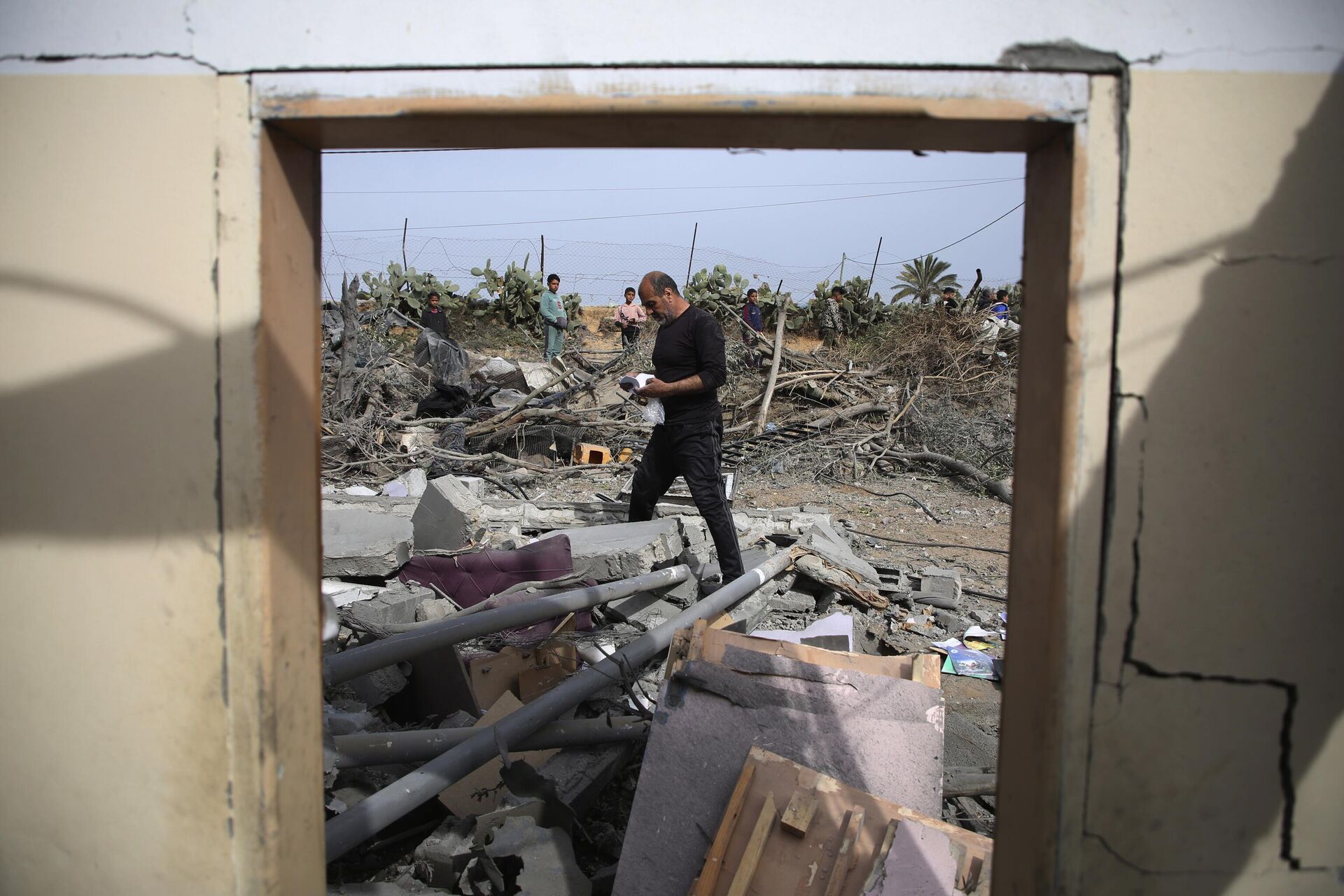 Palestinos inspecionam as ruínas de um prédio residencial após ataque aéreo israelense em Rafah, Faixa de Gaza, em 29 de março de 2024 - Sputnik Brasil, 1920, 26.04.2024