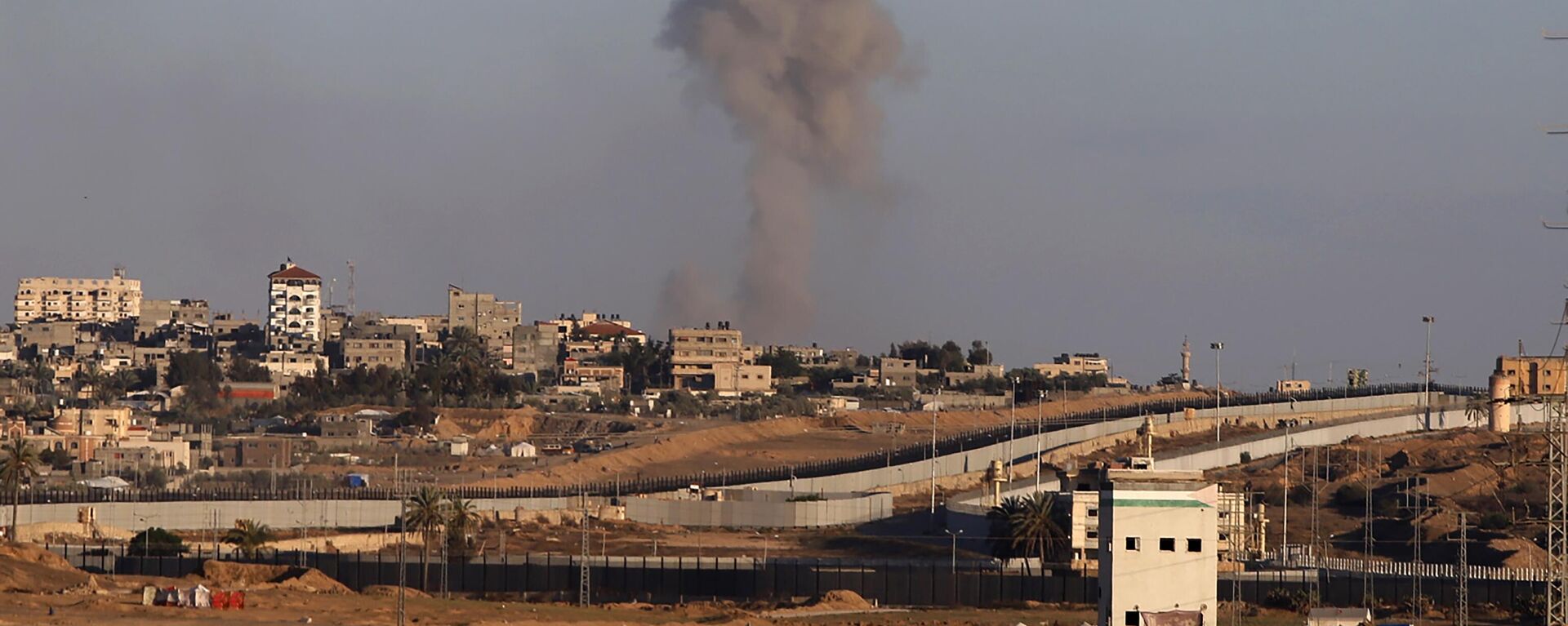 Fumaça sobe após um ataque aéreo israelense contra edifícios próximos ao muro que separa o Egito de Rafah, no sul da Faixa de Gaza, 6 de maio de 2024 - Sputnik Brasil, 1920, 07.05.2024