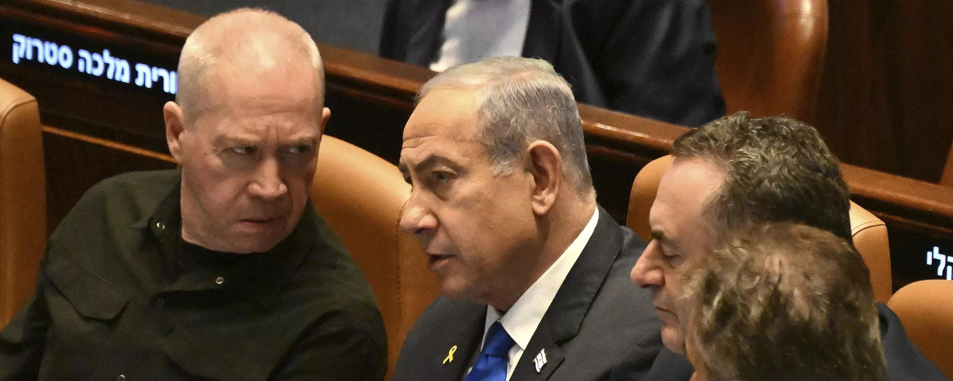 O primeiro-ministro israelense Benjamin Netanyahu (C), fala com o ministro da Defesa Yoav Gallant (E), na abertura da 25ª sessão do Knesset (parlamento), marcando o aniversário da operação Espadas de Ferro, em Jerusalém, 28 de outubro de 2024 - Sputnik Brasil, 1920, 10.11.2024