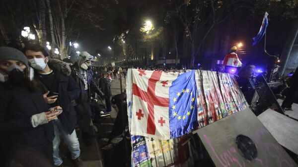 Manifestantes constroem uma barricada durante um comício do lado de fora do prédio do parlamento para protestar contra a decisão do governo de suspender as negociações para ingressar na União Europeia por quatro anos em Tbilisi, Geórgia, na manhã de domingo, 1º de dezembro de 2024. (Foto AP/Zurab Tsertsvadze) - Sputnik Brasil