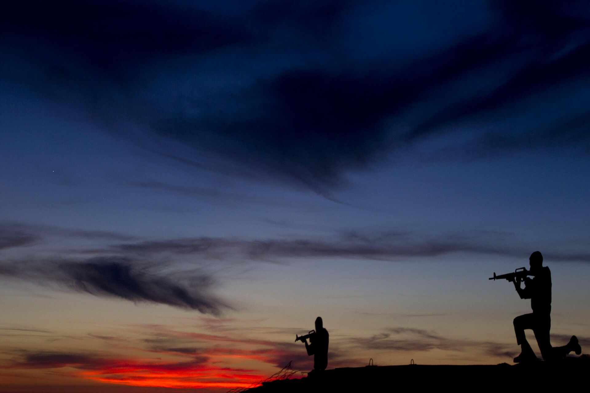 Cartazes de metal no formato de soldados israelenses em um antigo bunker durante o pôr do sol em um ponto de observação no Monte Bental, nas Colinas de Golã controladas por Israel, com vista para a fronteira com a Síria, 22 de maio de 2013