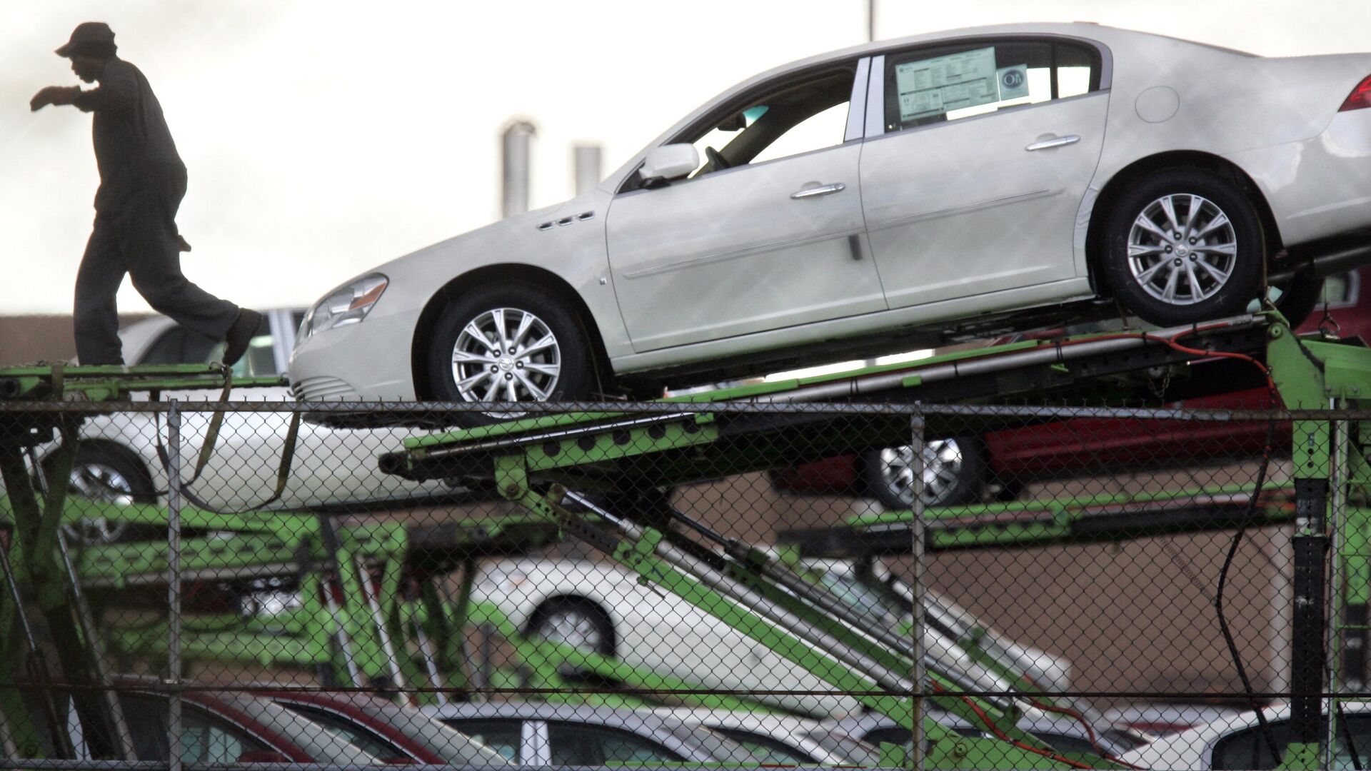Um trabalhador de transporte de automóveis carrega um Buick Lucerne da General Motors para transporte na Detroit/Hamtramck Assembly em Hamtramck, Michigan, 22 de abril de 2009 - Sputnik Brasil, 1920, 02.02.2025