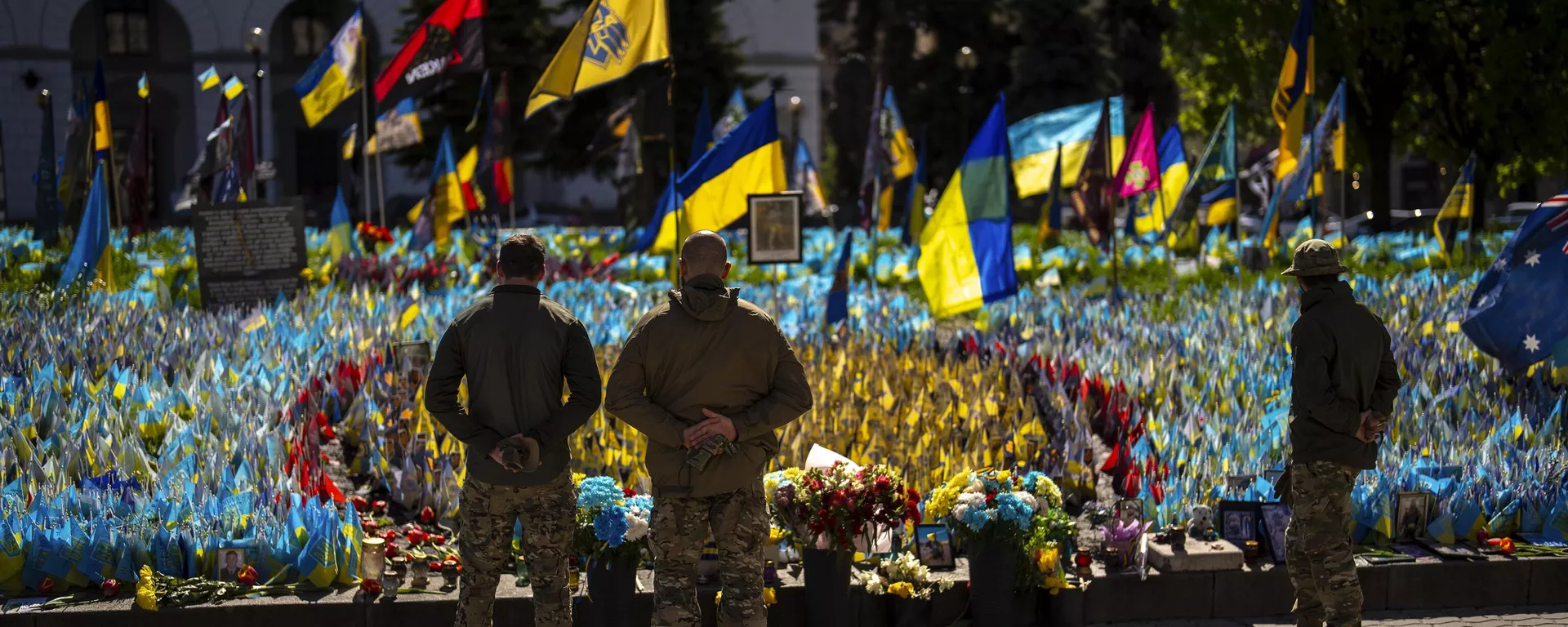 Militares ucranianos ao lado de bandeiras e fotografias ucranianas colocadas em memória de civis e soldados mortos durante o conflito, na Praça da Independência, no centro de Kiev, 20 de abril de 2024 - Sputnik Brasil, 1920, 02.02.2025