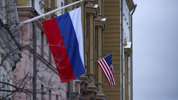 A embaixada dos EUA com uma bandeira nacional dos EUA, vista atrás de um prédio com uma bandeira nacional russa em Moscou, Rússia, 5 de novembro de 2024 - Sputnik Brasil