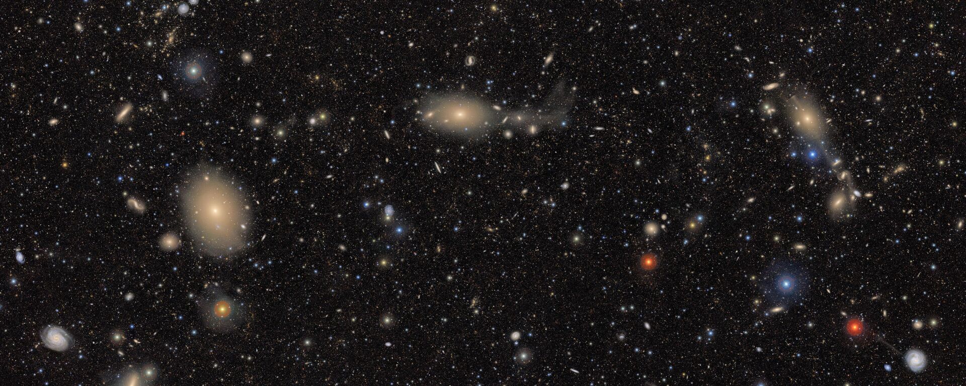 Esta imagem, uma das primeiras divulgadas pelo Observatório Rubin, expõe um Universo repleto de estrelas e galáxias — transformando bolsões de espaço aparentemente vazios e negros como tinta em tapeçarias brilhantes pela primeira vez. É possível observar uma variedade impressionante de objetos — de estrelas brilhantes que variam do azul ao vermelho, a galáxias espirais azuis próximas, a grupos de galáxias vermelhas distantes — demonstrando o potencial de processamento de Rubin - Sputnik Brasil, 1920, 10.09.2025