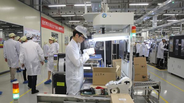 Um funcionário trabalha em uma linha de produção de celulares durante uma visita na fábrica da Huawei em Dongguan, província chinesa de Guangdong, 6 de março de 2019 - Sputnik Brasil