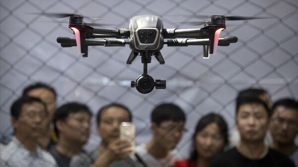 Visitantes assistem a um drone fabricado pela PowerVision pairar durante uma demonstração na Conferência Mundial de Robótica em Pequim, 24 de agosto de 2017 - Sputnik Brasil