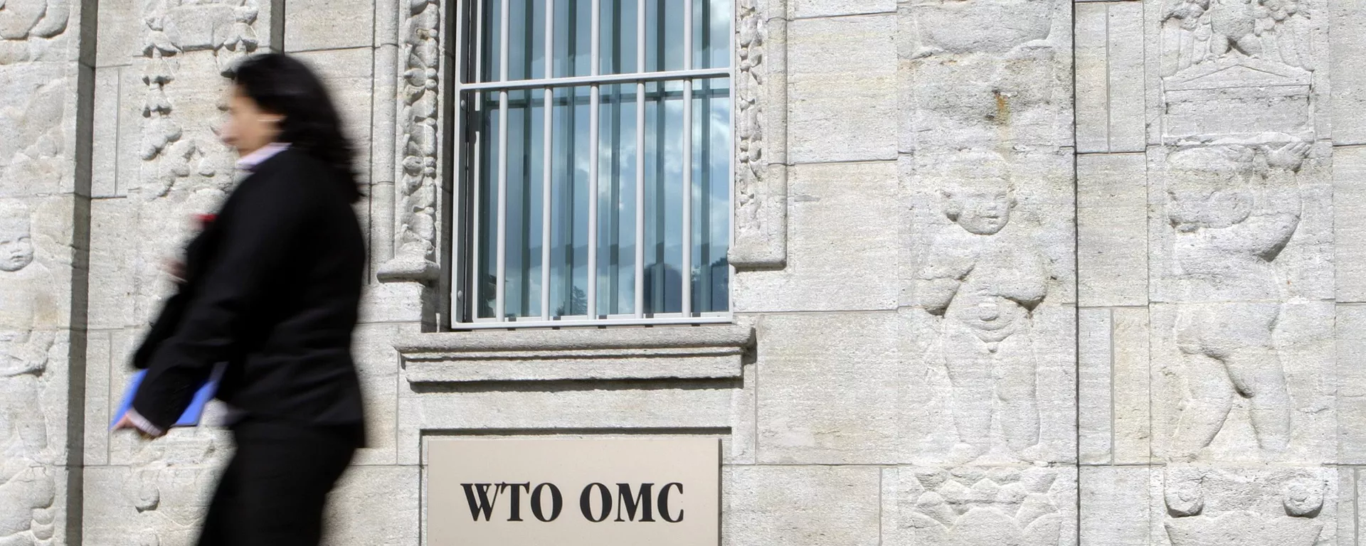 Um delegado caminha em frente à entrada do prédio da Organização Mundial do Comércio (OMC) em Genebra. Suíça, 22 de junho de 2007 - Sputnik Brasil, 1920, 19.08.2025