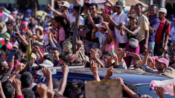 Militares são aplaudidos por manifestantes ao chegar para discursar para uma multidão, anunciando planos para assumir o governo e dissolver o Senado e a comissão eleitoral em Antananarivo. Madagascar, 14 de outubro de 2025 - Sputnik Brasil