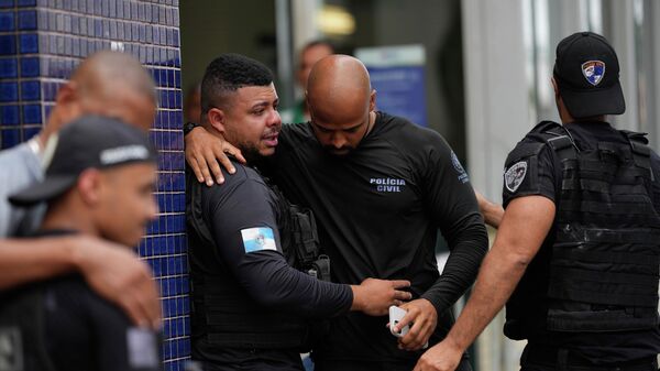 Policiais civis se consolam do lado de fora do Hospital Estadual Getulio Vargas, no Rio, em novembro de 2025 - Sputnik Brasil