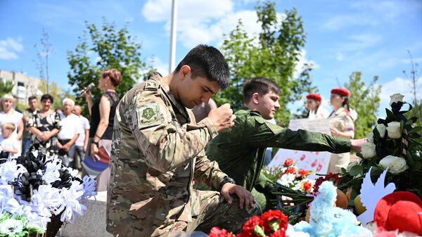 Participantes em uma cerimônia em memória das crianças vítimas da guerra no Donbass, no memorial dedicado às crianças - Sputnik Brasil