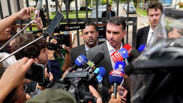 O senador Flávio Bolsonaro é abordado pela imprensa em frente à sede da Polícia Federal, em dezembro de 2025 - Sputnik Brasil