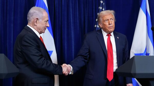 O presidente dos Estados Unidos, Donald Trump (à dir.), aperta as mãos do primeiro-ministro de Israel, Benjamin Netanyahu (à esq.), em dezembro de 2025 - Sputnik Brasil