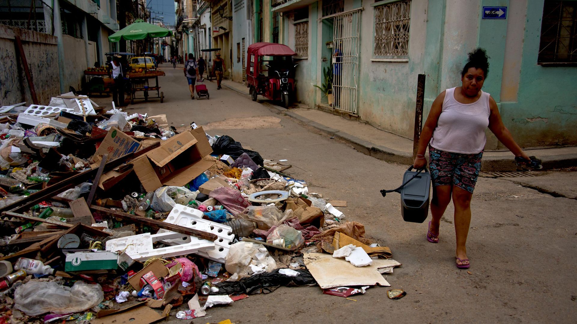 Moradora de Havana passa com água ao lado de pilha de lixo na capital de Cuba, em 6 de julho de 2026 Moradora de Havana passa com água ao lado de pilha de lixo na capital de Cuba, em 6 de julho de 2026 - Sputnik Brasil, 1920, 09.07.2026