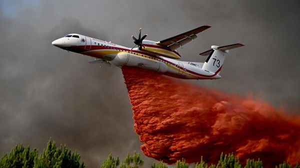 Um avião lança retardante de fogo enquanto sobrevoa uma floresta perto de Blagon, durante incêndios florestais no sudoeste da França, 29 de julho de 2026 - Sputnik Brasil