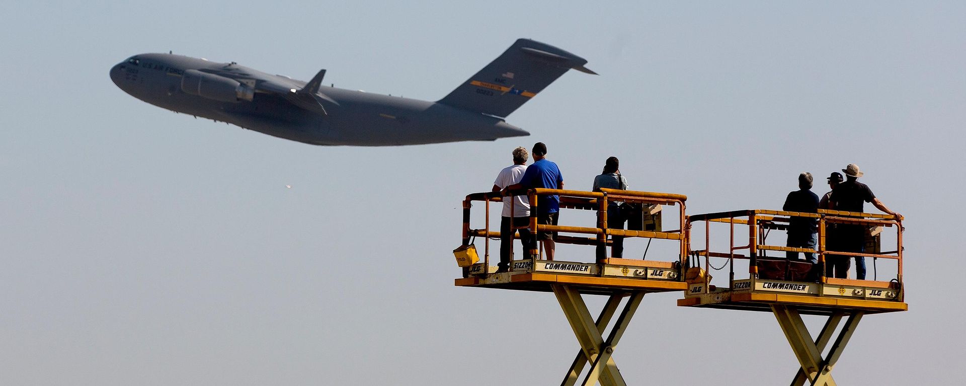 Funcionários da Boeing acenam para o último jato de carga C-17 Globemaster III construído para a Força Aérea dos EUA enquanto ele decola da fábrica da empresa aeroespacial em Long Beach, Califórnia, 12 de setembro de 2013 - Sputnik Brasil, 1920, 06.09.2026