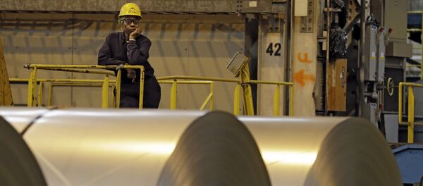 Um trabalhador olha por detrás de rolos de aço em Ohio, nos EUA, enquanto o secretário norte-americano do Trabalho, Seth Harris, discursa. - Sputnik Brasil
