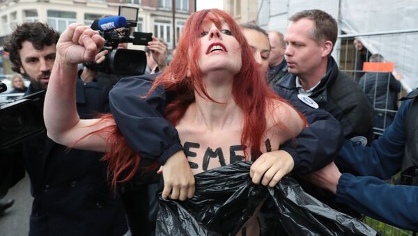 Polícia encobre os seios da mulher ativista do grupo Femen, durante os protestos contra a ex-candidata à presidência da França, Marine Le Pen, em Paris (foto de arquivo) - Sputnik Brasil
