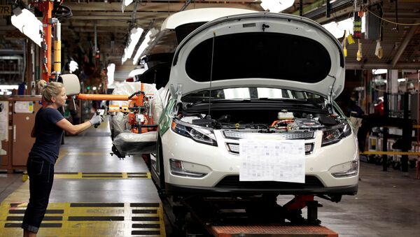 Membro do sindicato da United Auto Workers, Carrie Attwood, usa um braço ergonômico para instalar um banco dianteiro em um veículo elétrico Chevrolet Volt na fábrica da General Motors. - Sputnik Brasil