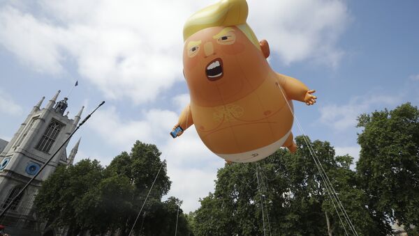 Um dirigível infantil de seis metros representando o presidente dos EUA, Donald Trump, é levado como protesto contra sua visita, ao Parliament Square, Londres. - Sputnik Brasil